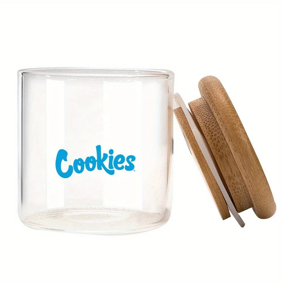 Clear glass jar with wooden lid and 'Cookies' branding on a white background