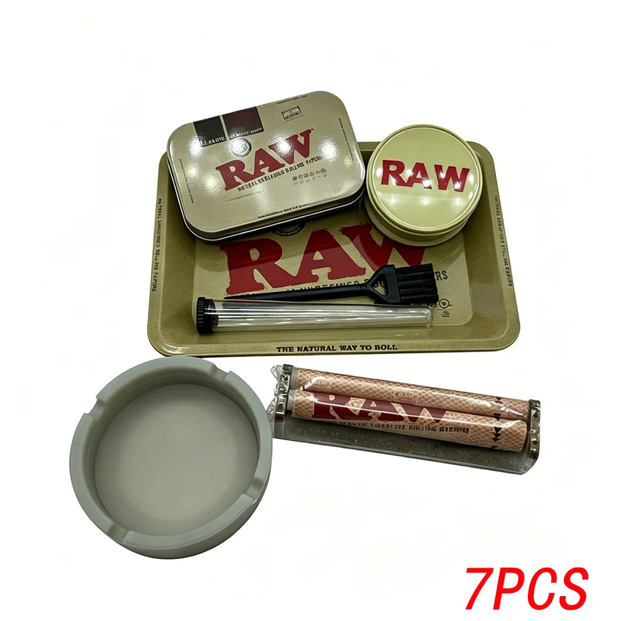 Raw smoking accessory set with tins, tray, and other items on a white background