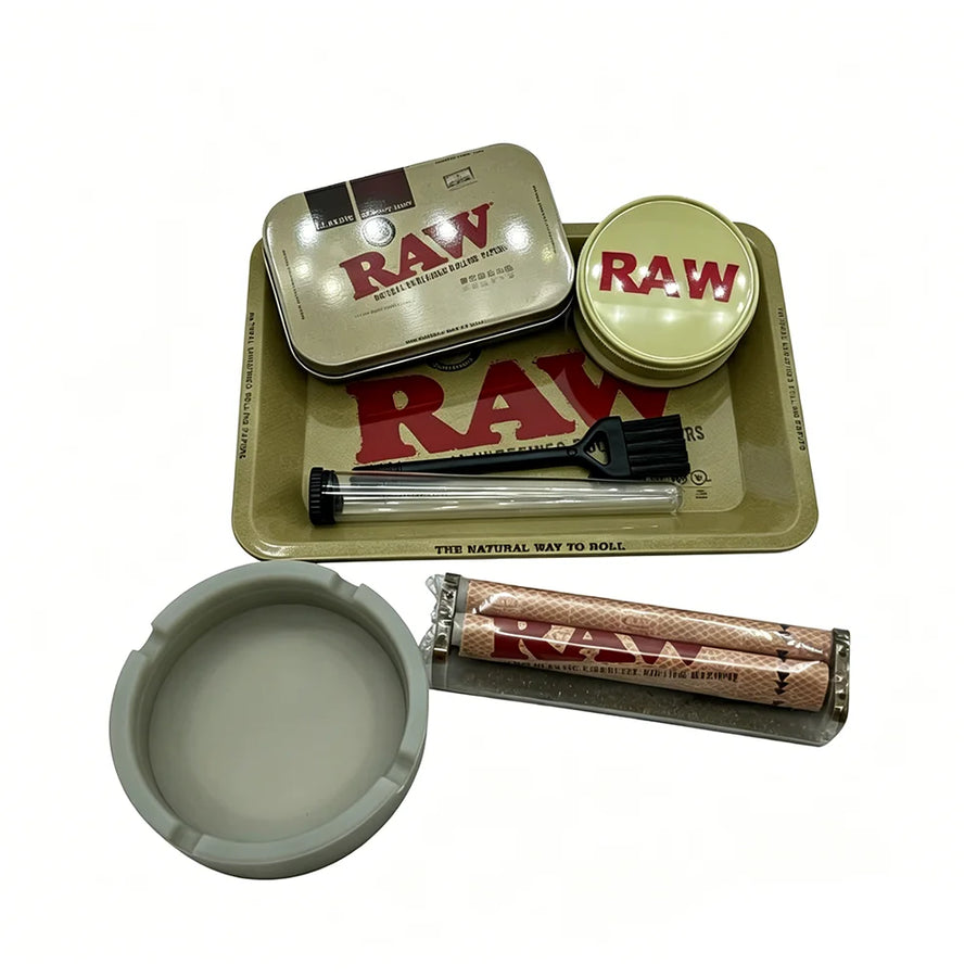 RAW smoking accessories including tins, tray, and rolling tools on a white background