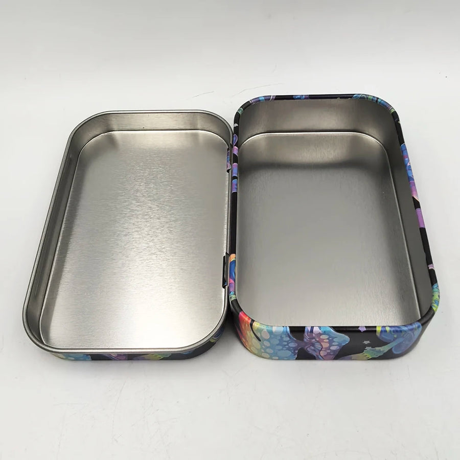 Two metal trays, one with a floral pattern and one plain, on a white background